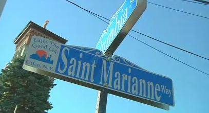 The street Mother Marianne Cope grew up on in Utica, New York is now mamed St. Marianne Way. That is her parish church St. Joseph/St. Patrick in the background. Photo by Susie Lloyd