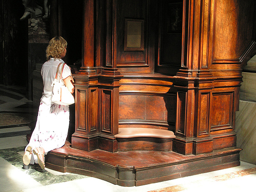 woman kneeling in confession