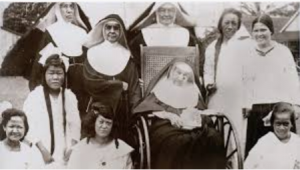 Mother Marianne (seated) with her lepers and fellow Franciscans